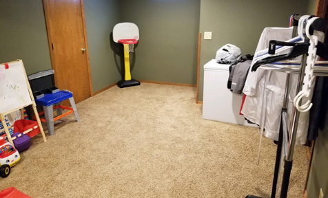 Before: Before Renovations, The Basement Was Used As A Storage Space. The Walls Were Painted A Neutral Shade Of Green That Neither Stephanie Nor Jordan Liked.